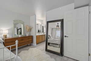 Bedroom featuring ensuite bath and light hardwood / wood-style flooring