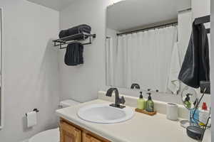 Bathroom featuring vanity and toilet