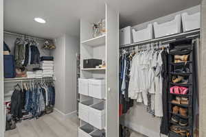 Spacious closet with light wood-type flooring