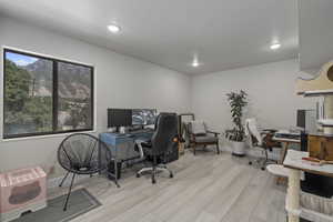 Office space with heating unit and light wood-type flooring