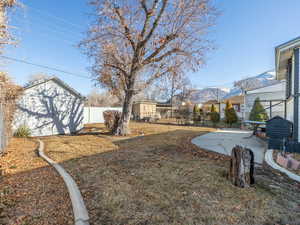 View of yard featuring a shed and a patio