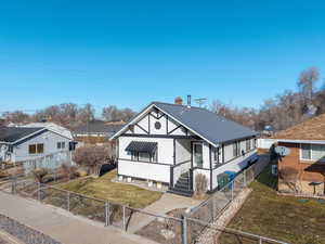 Bungalow-style house with a front lawn