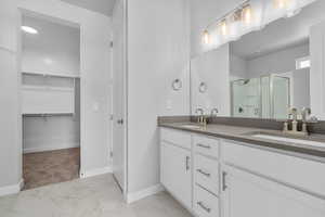 Bathroom featuring vanity and walk in shower