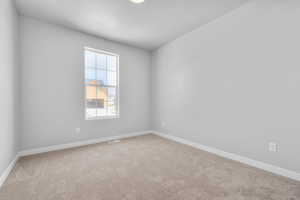 Spare room featuring carpet floors