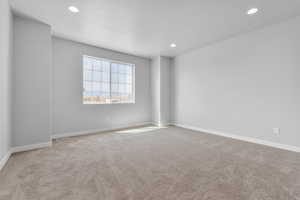 Unfurnished room with light carpet and a textured ceiling