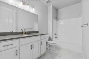 Full bathroom with shower / bathing tub combination, vanity, and toilet