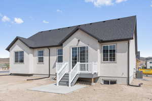 Rear view of property featuring cooling unit