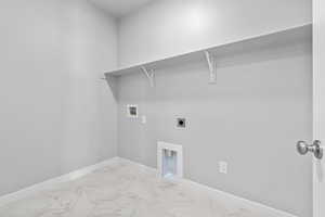 Laundry area featuring washer hookup and electric dryer hookup