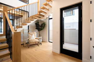 Stairs featuring hardwood / wood-style floors