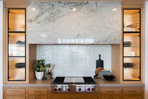 Kitchen featuring tasteful backsplash and stainless steel gas cooktop