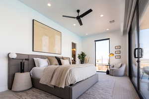 Carpeted bedroom featuring ceiling fan