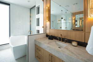 Bathroom with vanity and separate shower and tub