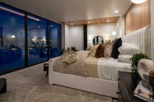 Carpeted bedroom with floor to ceiling windows