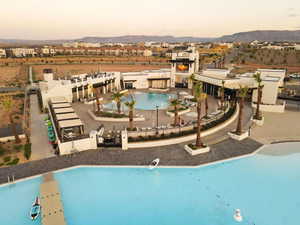 Pool at dusk featuring a mountain view