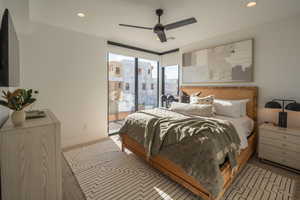 Carpeted bedroom featuring access to outside and ceiling fan