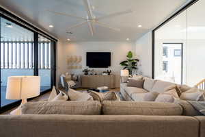 Living room with hardwood / wood-style floors and ceiling fan