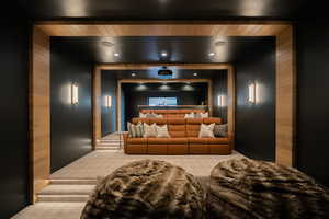 Carpeted home theater with wooden walls