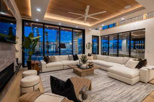 Living room with hardwood / wood-style floors, wooden ceiling, a wall of windows, and a tray ceiling