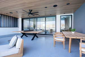 Game room featuring ceiling fan, wood ceiling, and a wall of windows