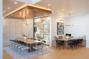 Dining room with a notable chandelier and light hardwood / wood-style flooring