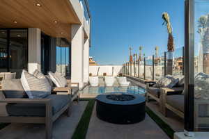 View of patio with a balcony