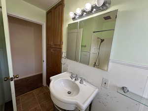 Bathroom with sink and tile patterned floors