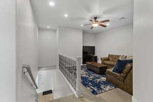 Living area with recessed lighting, a ceiling fan, and carpet floors