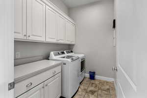 Laundry room with cabinet space and washing machine and clothes dryer