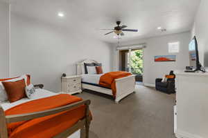 Bedroom featuring access to exterior, carpet floors, recessed lighting, a ceiling fan, and a textured ceiling