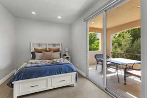 Bedroom with carpet flooring, access to outside, and recessed lighting