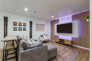 Living room featuring wood-type flooring and a textured ceiling