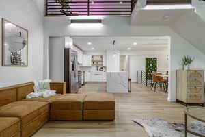 Living room featuring sink and light wood-type flooring