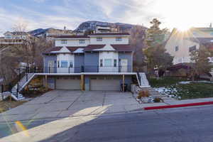 View of front of home with a mountain view and a garage