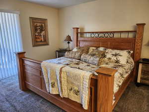 Bedroom featuring dark carpet