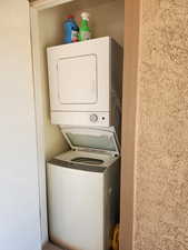 Laundry area featuring stacked washer and dryer