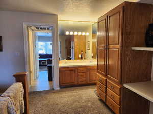 Bathroom featuring vanity and a textured ceiling