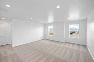 Loft featuring a textured ceiling