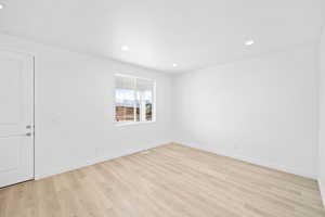 Spare room featuring light wood-type flooring