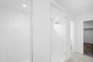 Bathroom featuring tile patterned flooring and tiled shower