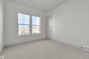 Spare room with light colored carpet