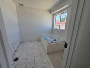Bathroom featuring marble finish floor