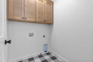 Washroom with cabinets, electric dryer hookup, washer hookup, and hookup for a gas dryer