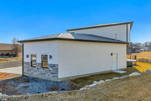 View of side of home with central AC unit