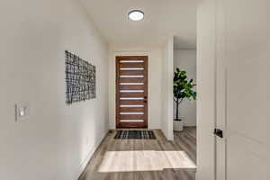 Foyer entrance with light wood-type flooring