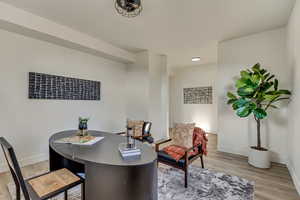 Home office with light hardwood / wood-style flooring