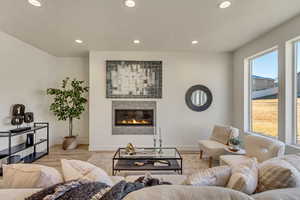 Living room with a fireplace and light wood-type flooring