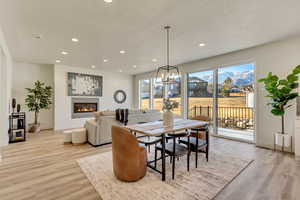 Dining space featuring a chandelier, light hardwood / wood-style floors, and a textured ceiling