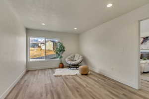 Unfurnished room with a textured ceiling and light hardwood / wood-style floors