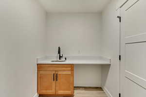 Interior space with light hardwood / wood-style floors and sink