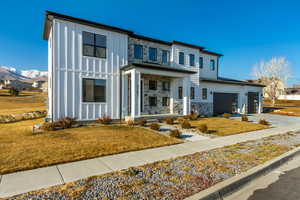 View of front facade with a mountain view and a front lawn